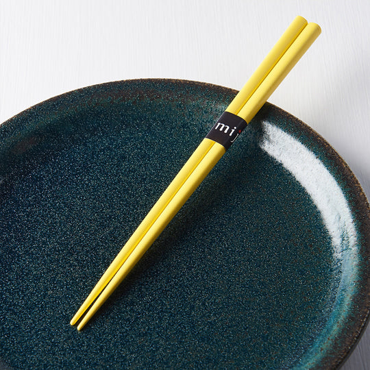 Yellow Textured Lacquerware Chopsticks from Made in Japan. This Chopstick collection is designed and made at the Zumi workshop in Fukui prefecture, Japan. This region of Japan has a 1500-year-old history of crafting with Lacquer.  Detail view