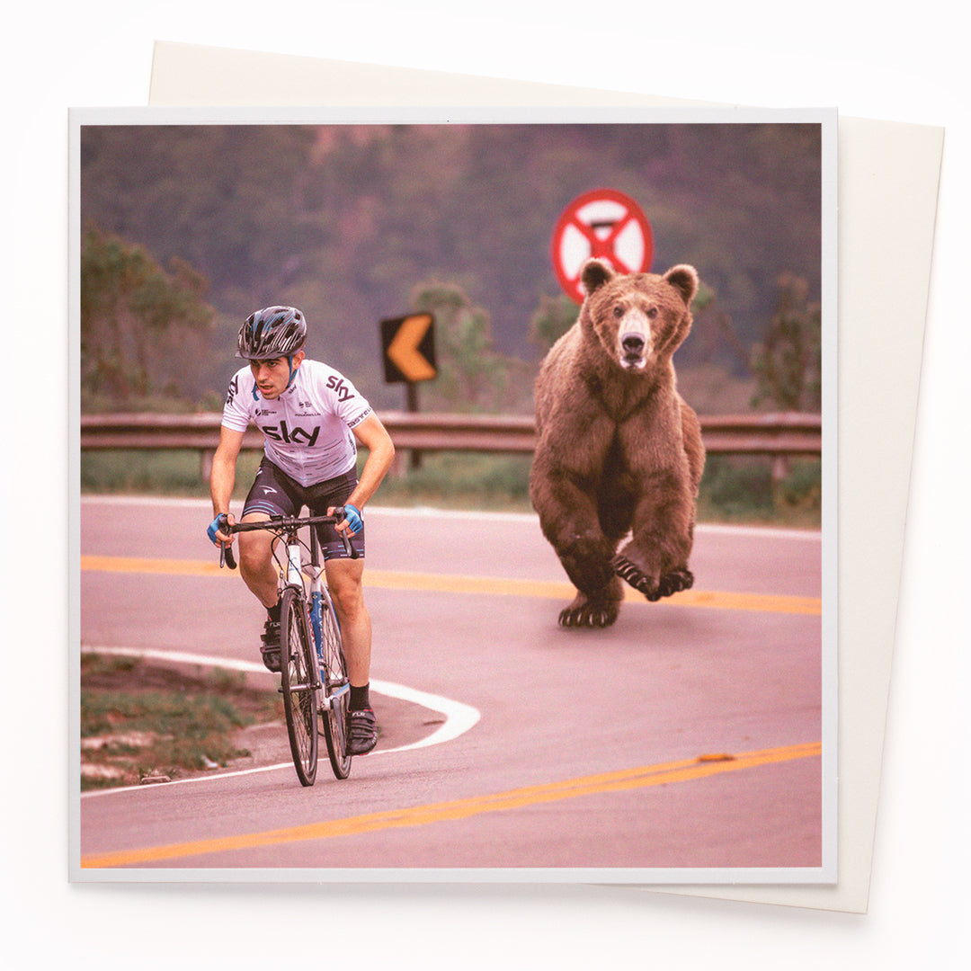 The 'Bear Chasing Cyclist' card is part of the 1000 Words - Slice of life licensed photography collection with a focus on animal shenanigans and the ridiculous.