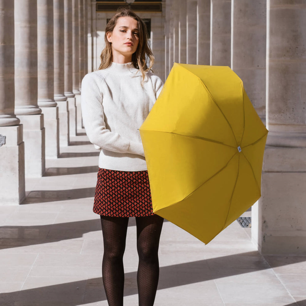 Anatole bright yellow umbrella, the ideal folding umbrella for urban lifestyles.  These high-quality, strong and ultra-lightweight micro-umbrellas easily fit into a coat pocket or handbag.  Features a maple wood handle, opens out to 84cm diameter, measures 17.5cm when folded and weighs 220g.