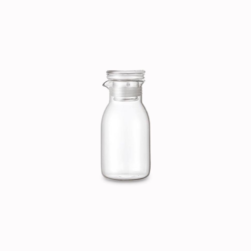 Small heat resistant glass bottle with air tight lid and pourer, suitable for salad dressing. Silicone rim on lid for a snug fit from Kinto - Japanese Tableware
