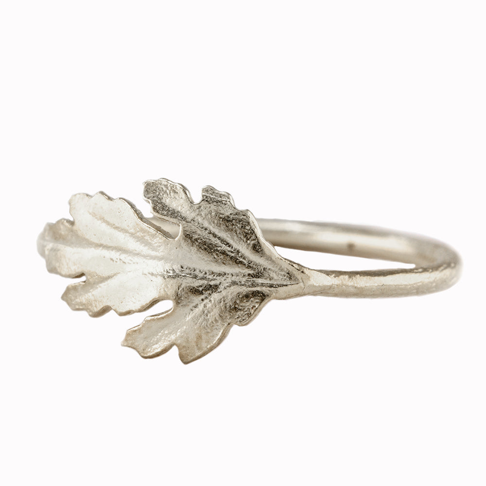A single chrysanthemum leaf flows around the finger in this beautiful botanical ring by London based jeweller Alex Monroe.