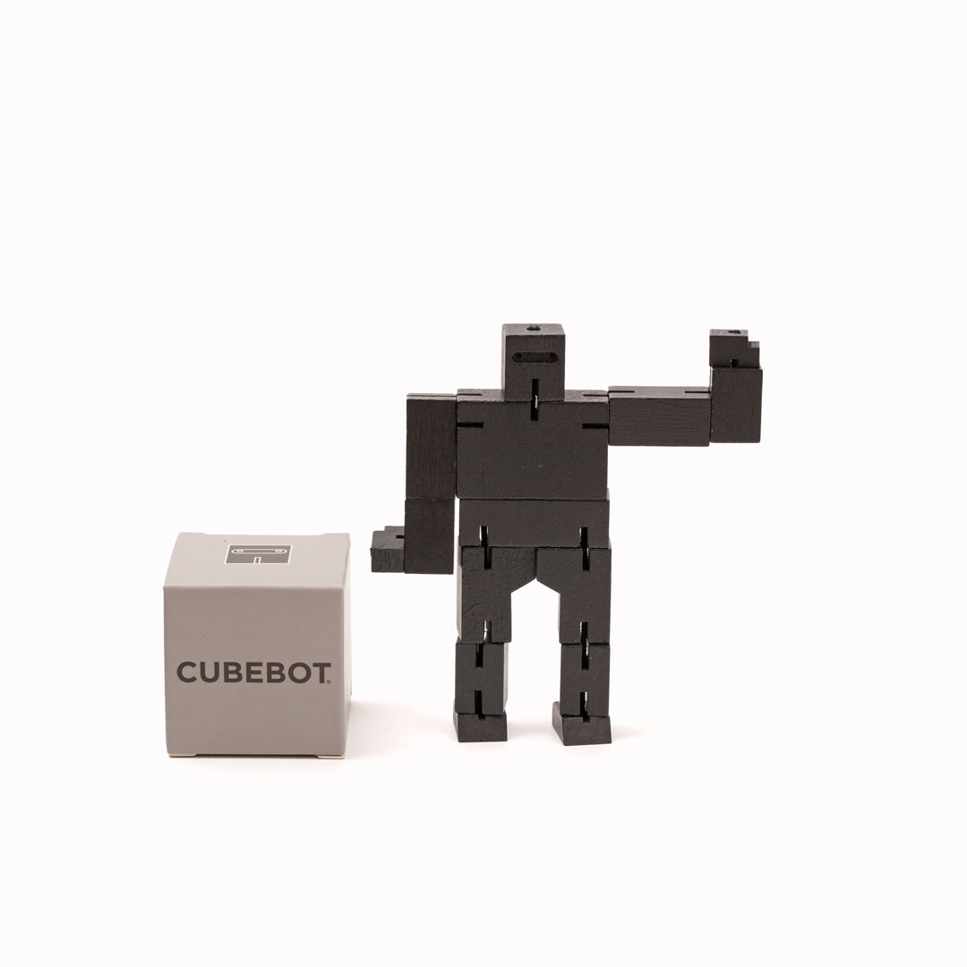 Cubebot is a fun wooden toy robot that folds out of a perfect cube shape. Part puzzle, part posable toy they are inspired by Japanese Shinto Kumi-ki puzzles and can be positioned to hold dozens of poses.   Made from Beech and elastic Posable and decorative 11 cm tall, 14 cm arm span