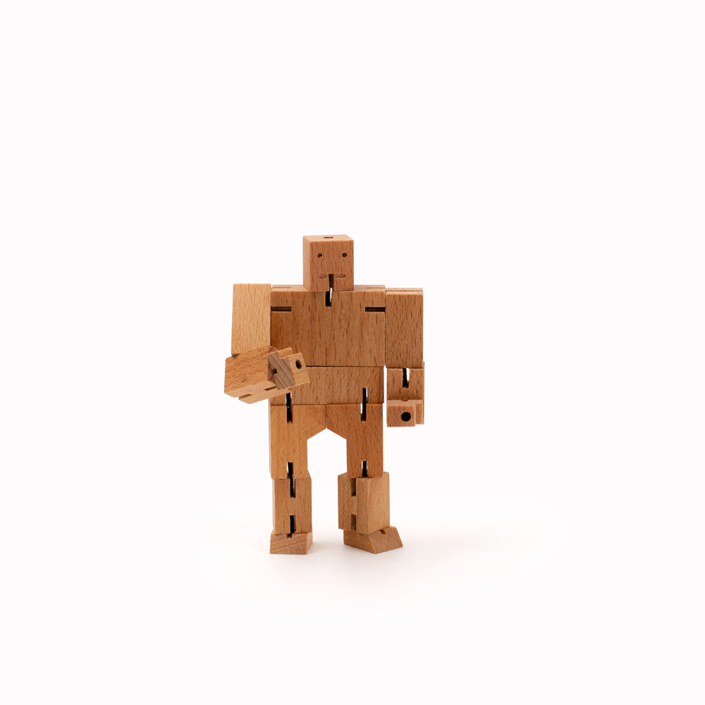 Cubebot by Areaware is a fun wooden toy robot that folds out of a perfect cube shape. Part puzzle, part posable toy they are inspired by Japanese Shinto Kumi-ki puzzles and can be positioned to hold dozens of poses.   Made from Beech and elastic, water based paint. Posable and decorative. 11 cm tall, 14 cm arm span.