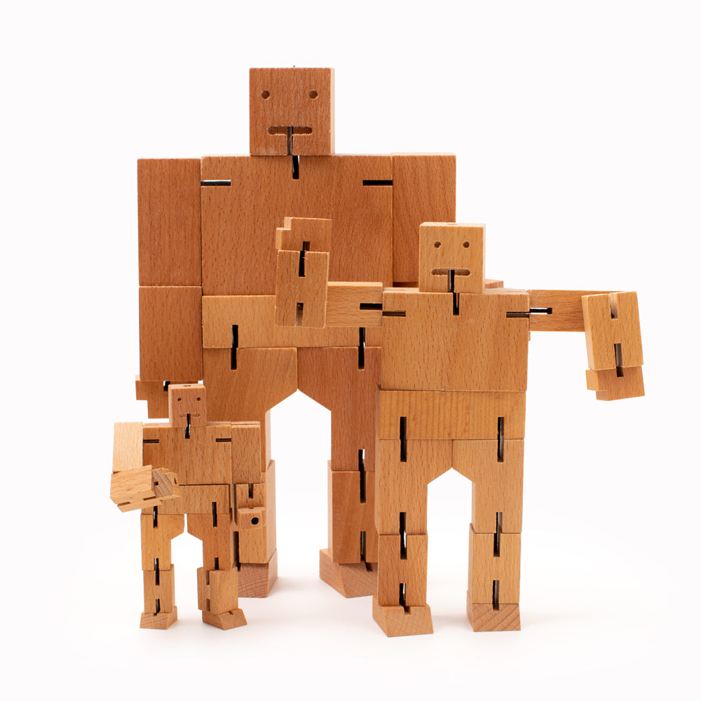 Cubebot by Areaware (micro, small and medium) is a fun wooden toy robot that folds out of a perfect cube shape. Part puzzle, part posable toy they are inspired by Japanese Shinto Kumi-ki puzzles and can be positioned to hold dozens of poses. Made from Beech and elastic Posable and decorative .