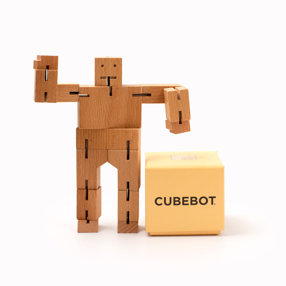 Cubebot is a fun wooden toy robot that folds out of a perfect cube shape. Part puzzle, part posable toy they are inspired by Japanese Shinto Kumi-ki puzzles and can be positioned to hold dozens of poses.   Made from Beech and elastic Posable and decorative 17 cm tall, 23.5 cm arm span