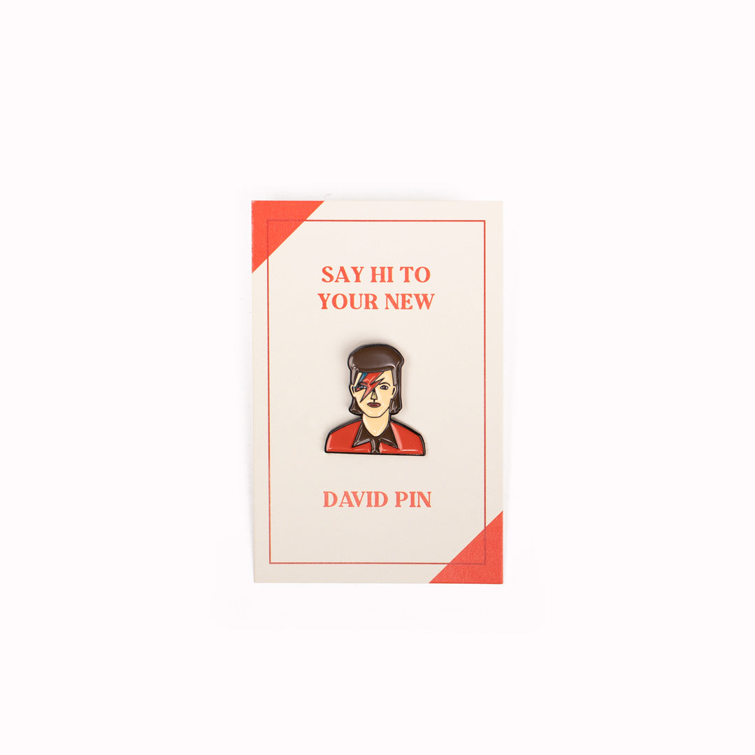 Pin badge design with backing card packaging by Judy Kauffman of David Bowie as classic lightning faced Aladdin Sane