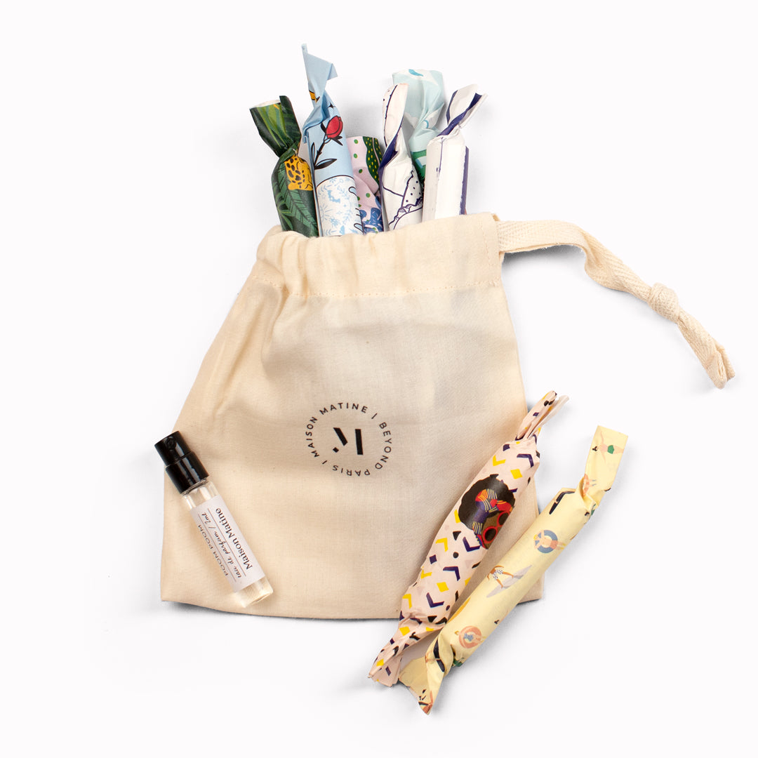A delicious gift of 9 taster scents from Maison Matine, presented in beautifully illustrated candy wrappers in a small cotton bag. Wrapped bottles in and around cotton bag.