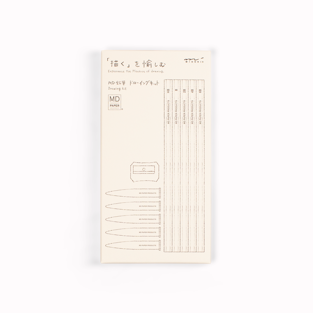 Showing box. Stylish, minimal drawing set of pencils from Japanese stationery brand, MD Paper, in their trademark subtle off-white colour scheme. This set includes five graphite pencils in assorted hardness (6B, 4B, 2B, B, HB) with protective toppers and a sharpener.
