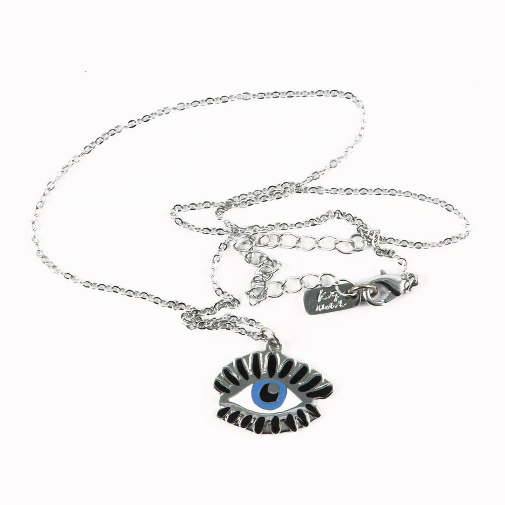 Silver plated Evil Eye necklace from Katy Welsh for USTUDIO presented on a laser-etched birch ply board.