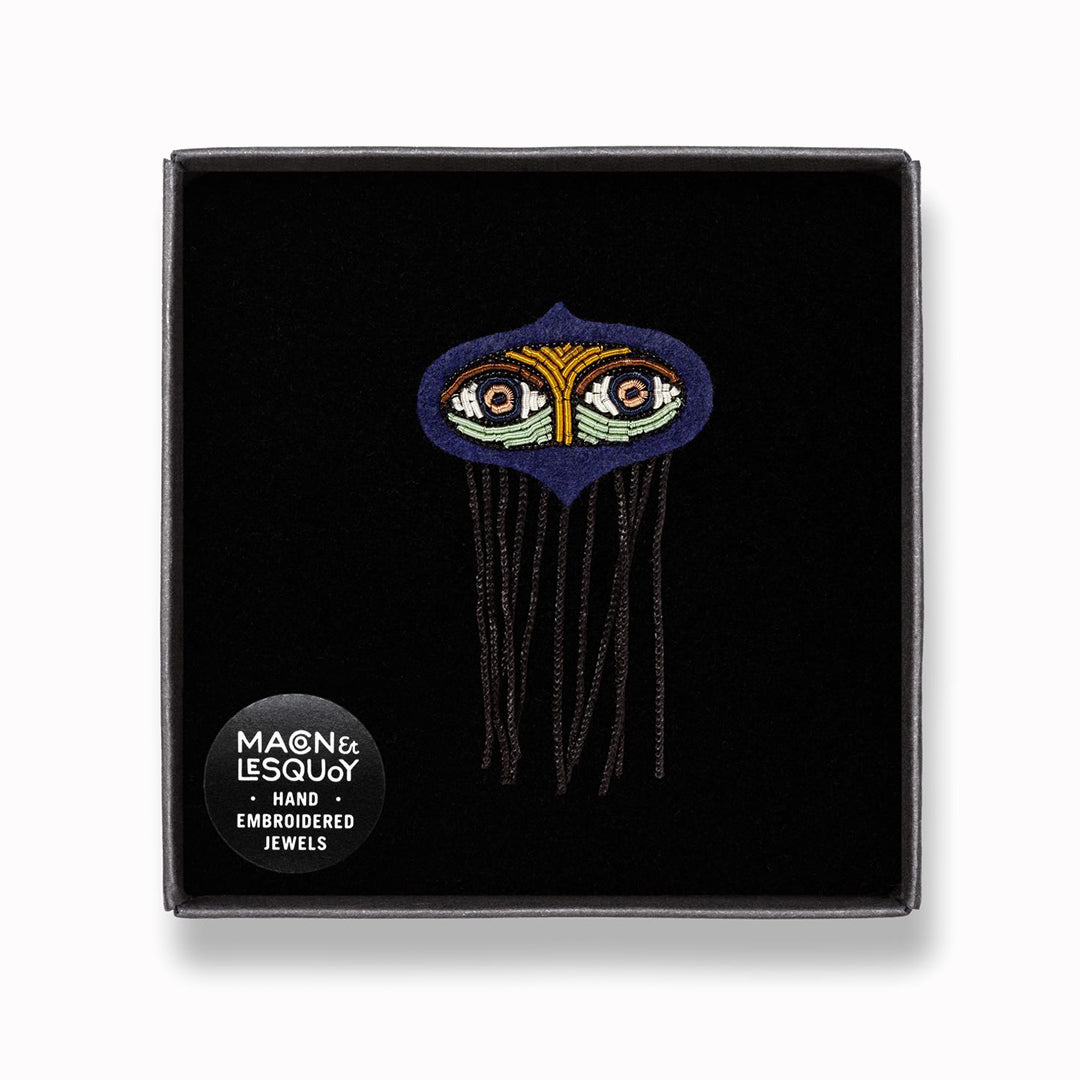 Ward off the evil eye with this beautiful, hand-embroidered Fatima Eyes lapel pin in a presentation box From Macon & Lesquoy, French Hand Embroidered badges and patches using Cannetille thread.