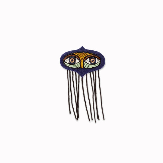 Ward off the evil eye with this beautiful, hand-embroidered Fatima Eyes lapel pin, From Macon & Lesquoy, French Hand Embroidered badges and patches using Cannetille thread.