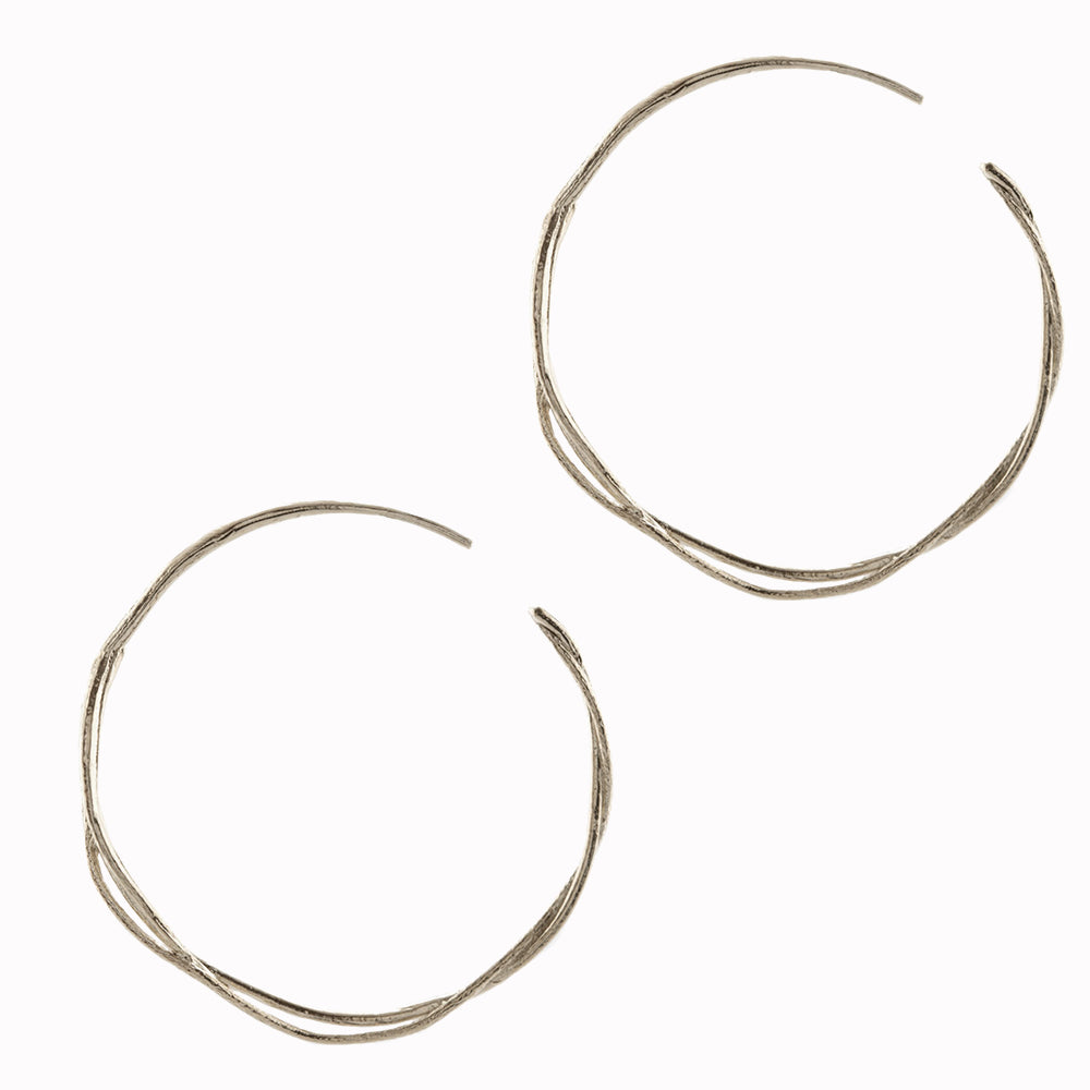 A single vine has curled and twisted around itself to create a pair of elegant, contemporary hoop earrings. Perfect for mixing and matching with other Alex Monroe earrings.