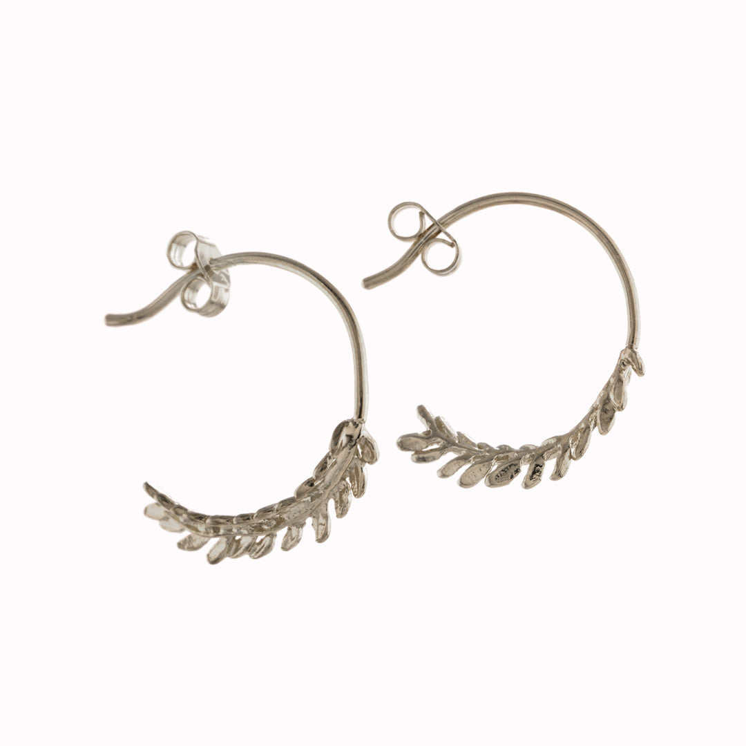 Silver Elegant honey fern curves to form a pair of elegant, contemporary hoop earrings by nature inspired Alex Monroe. Perfect for mixing and matching with other Alex Monroe earrings. available in Gold or Silver