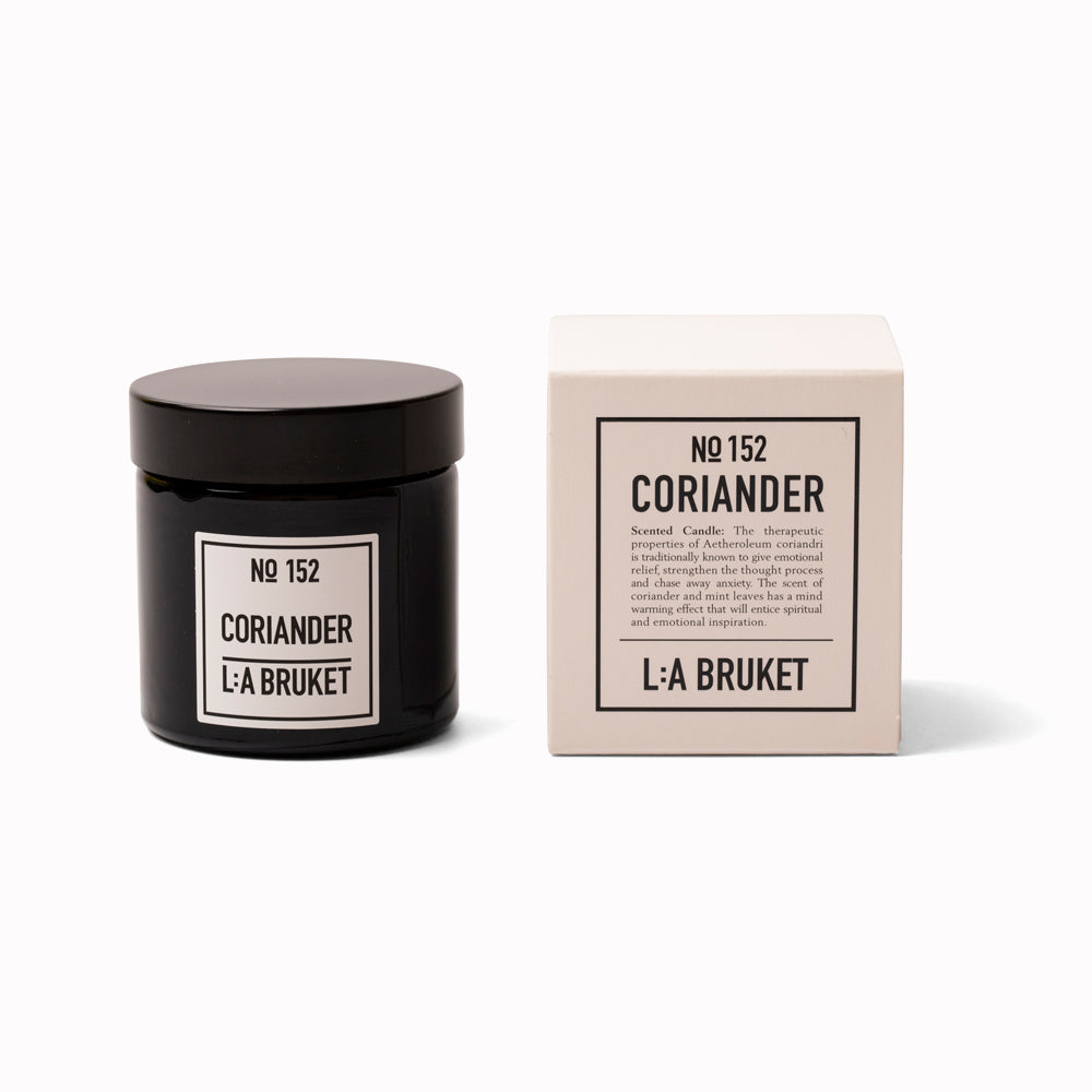 Coriander Travel Sized Scented Candle with Box from L:A Bruket. Scented travel candle from L:A Bruket, made of wax from organic soy with a burn time of more than 15 hours. The candle is filled by hand in a mouth-blown tinted amber glass. A best-selling soy candle from L:A Bruket.