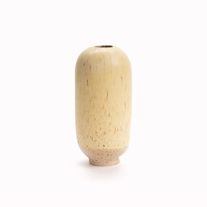 The pale subtle yellow speckle 'Lemon Zest' design is hand-thrown in watertight stoneware and due to the rounded taper at the top of the vase, the glaze melts down the sides of the cylindrical vase mimicking melting ice.   Each piece is handmade in Denmark from the Arhoj studio in Copenhagen. This means the glaze colour and finish will never be exactly the same on any two items, and this is absolutely a part of their unique appeal.  