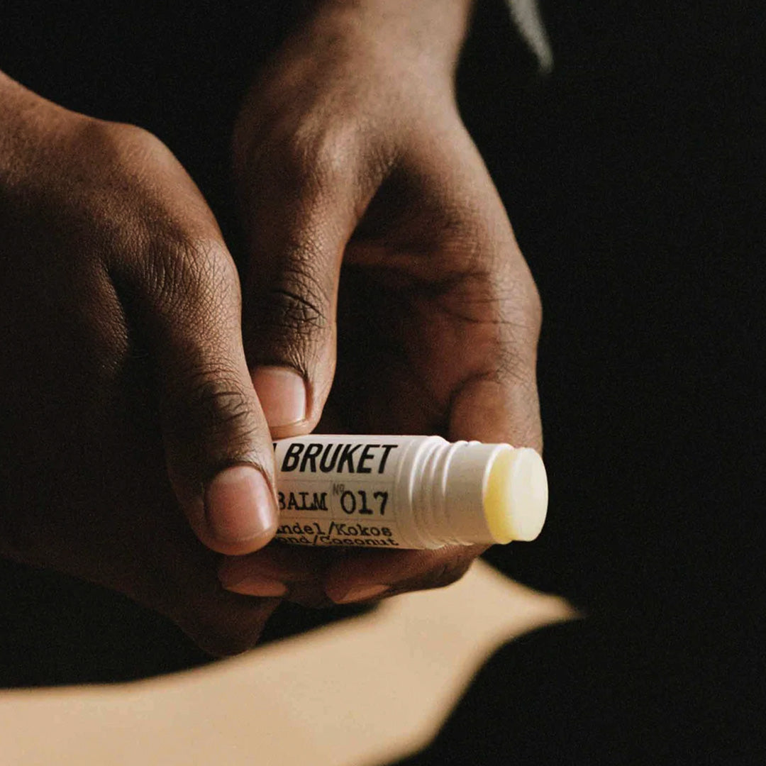 Almond and Coconut Lip Balm Lifestyle | 017 | L:A Bruket, in model's hands. Leaves lips soft and well-moisturised. A best-selling lip balm from L:A Bruket.