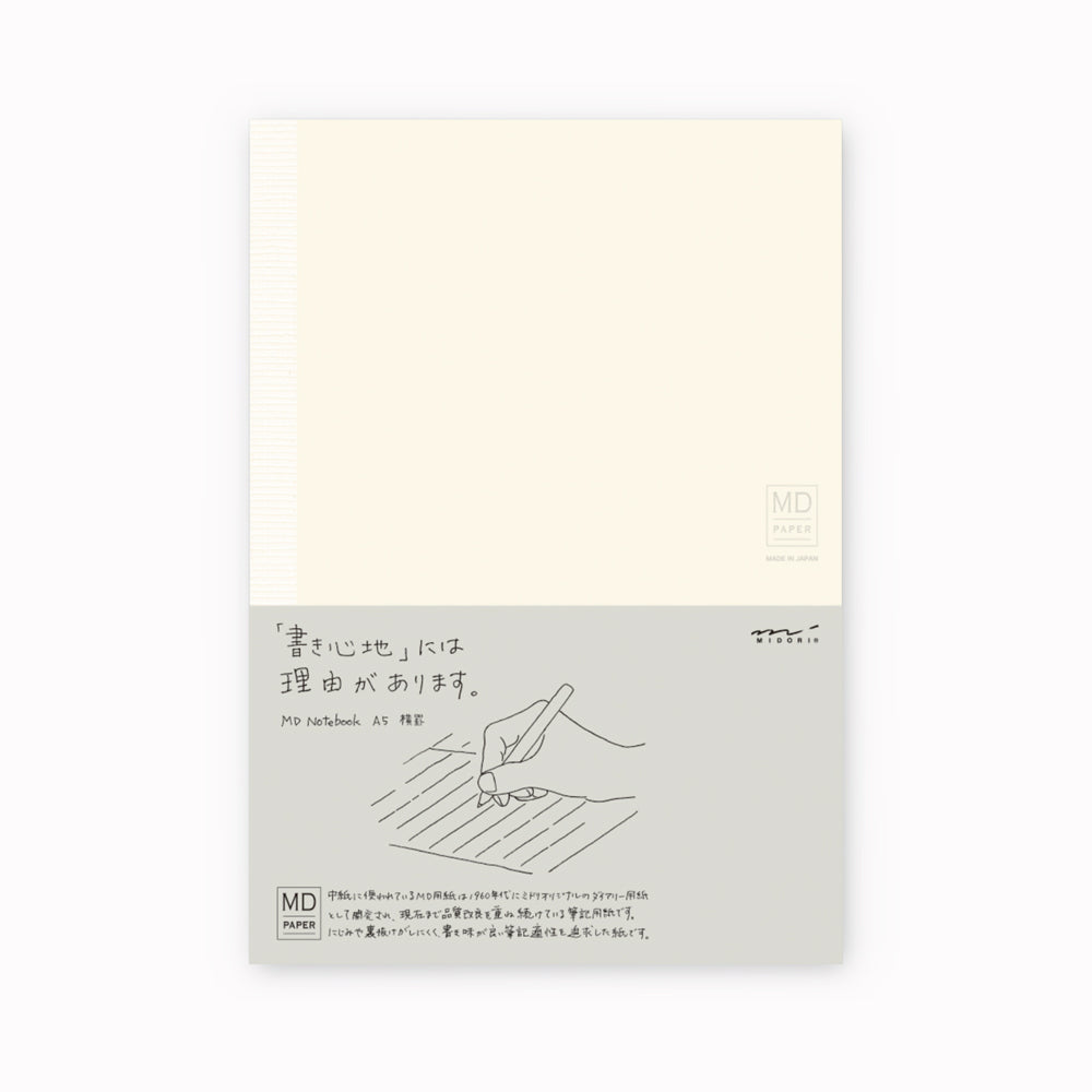 Showing notebook cover. A5 ruled paper notebook with a simple and clean off white cover and embossed MD Paper logo. MD-Paper epitomises the subtlety, elegance and simplicity of design of good Japanese stationery, concentrating on the quality of material over branding or printed design. This 176 page notebook features a ruled layout and lay-flat binding, with a paraffin paper cover for a touch of elegance.