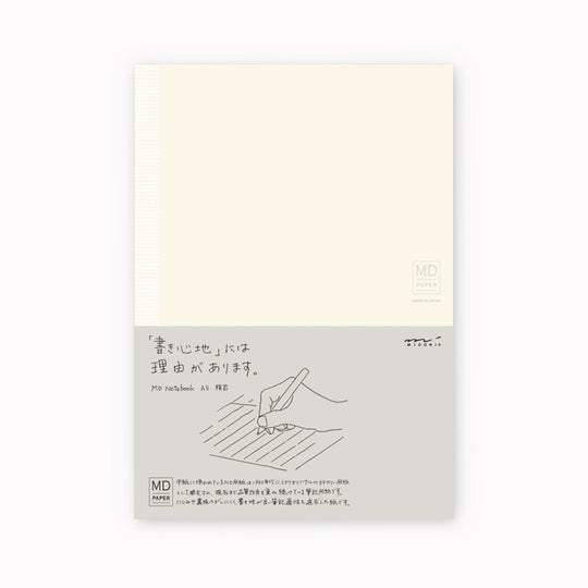 Showing notebook cover. A5 ruled paper notebook with a simple and clean off white cover and embossed MD Paper logo. MD-Paper epitomises the subtlety, elegance and simplicity of design of good Japanese stationery, concentrating on the quality of material over branding or printed design. This 176 page notebook features a ruled layout and lay-flat binding, with a paraffin paper cover for a touch of elegance.