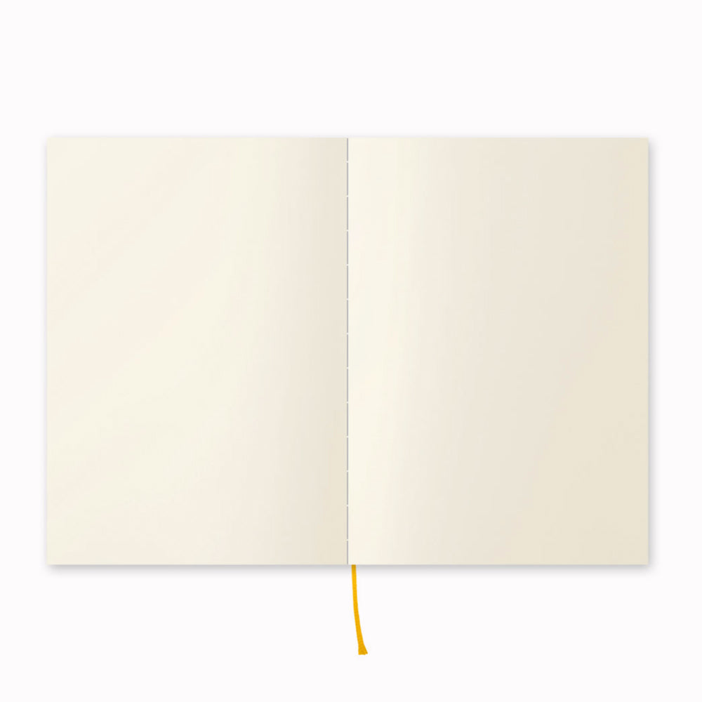 Showing notebook open flat. A5 plain paper notebook with a simple and clean off white cover and embossed MD Paper logo. MD Paper epitomises the subtlety, elegance and simplicity of design of good Japanese stationery, concentrating on the quality of material over branding or printed design. This 176 page notebook features a plain layout and lay-flat binding, with a paraffin paper cover for a touch of elegance.