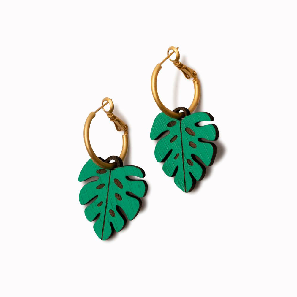 Monstera hoop earrings by Miriam Frank for Materia Rica. Inspired by illustration, the world of tattooing and the love of wildlife, Miriam Frank's designs have become beautiful earrings and necklaces. The walnut pieces have been laser cut and hand-painted in bright colours to create their quirky jewellery