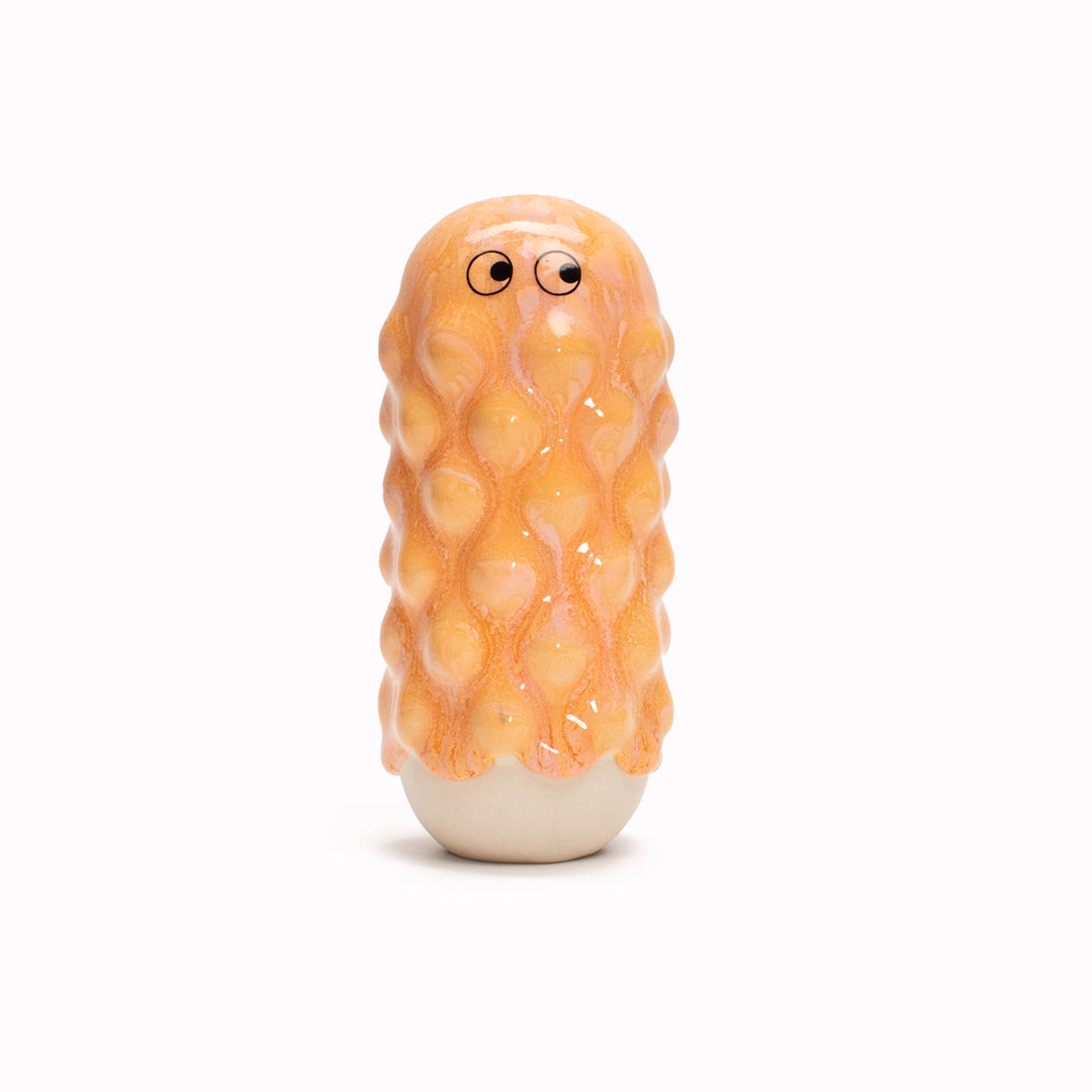 Peach Mimi, a barnacle encrusted, bobbly, hand glazed ceramic figurine created as a close relative of the classic Arhoj Ghost. 