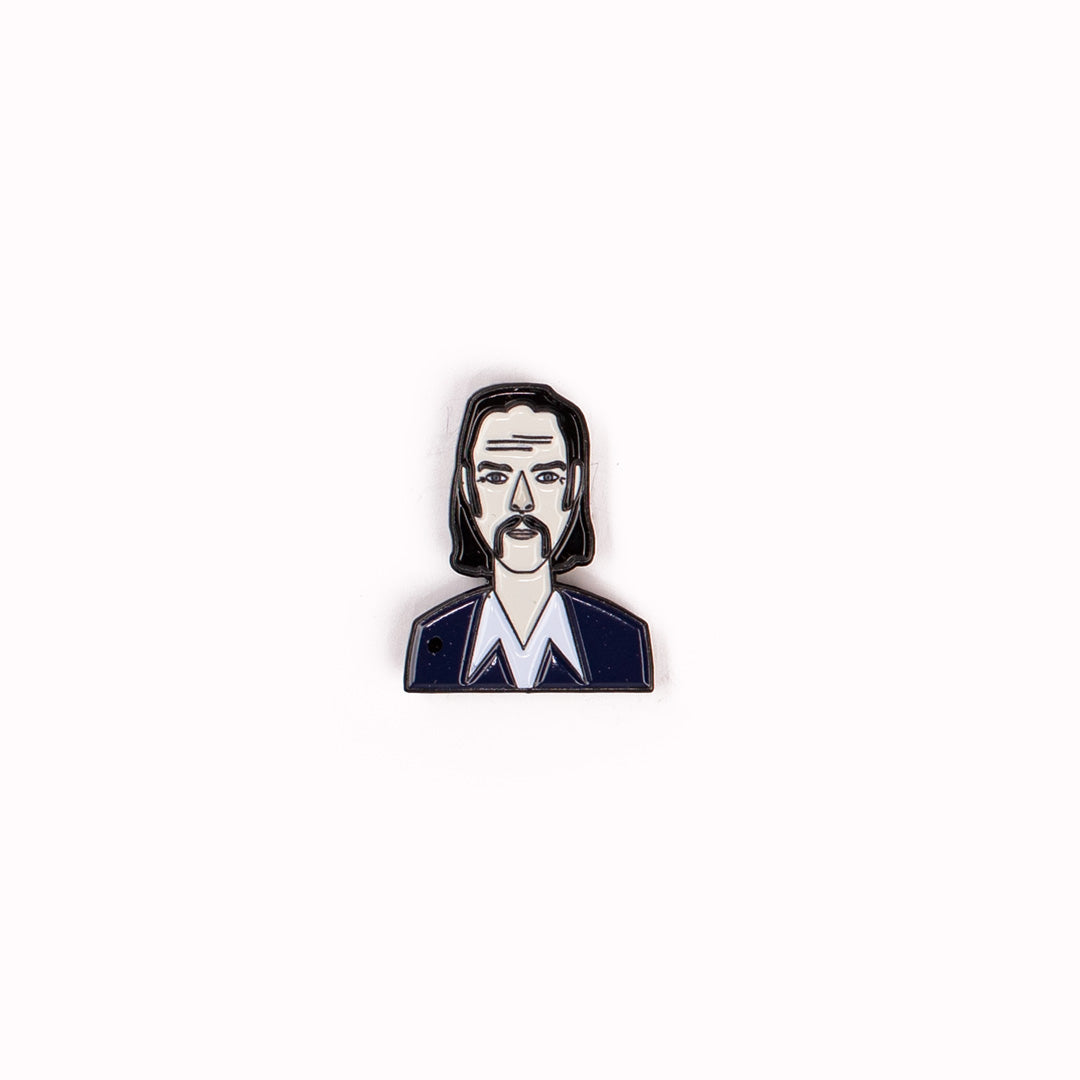 Enamel pin badge by Judy Kauffman of illustrated melancholic post-punk Australian songwriter and poet, Nick Cave. 
