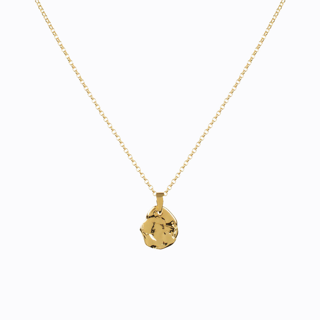 Hand carved gold vermeil textured pendant on an 18 inch chain by Matthew Calvin. Reminiscent of antique and molten coins, it's perfect for layering and a classic staple piece of jewellery either stacked or worn alone.