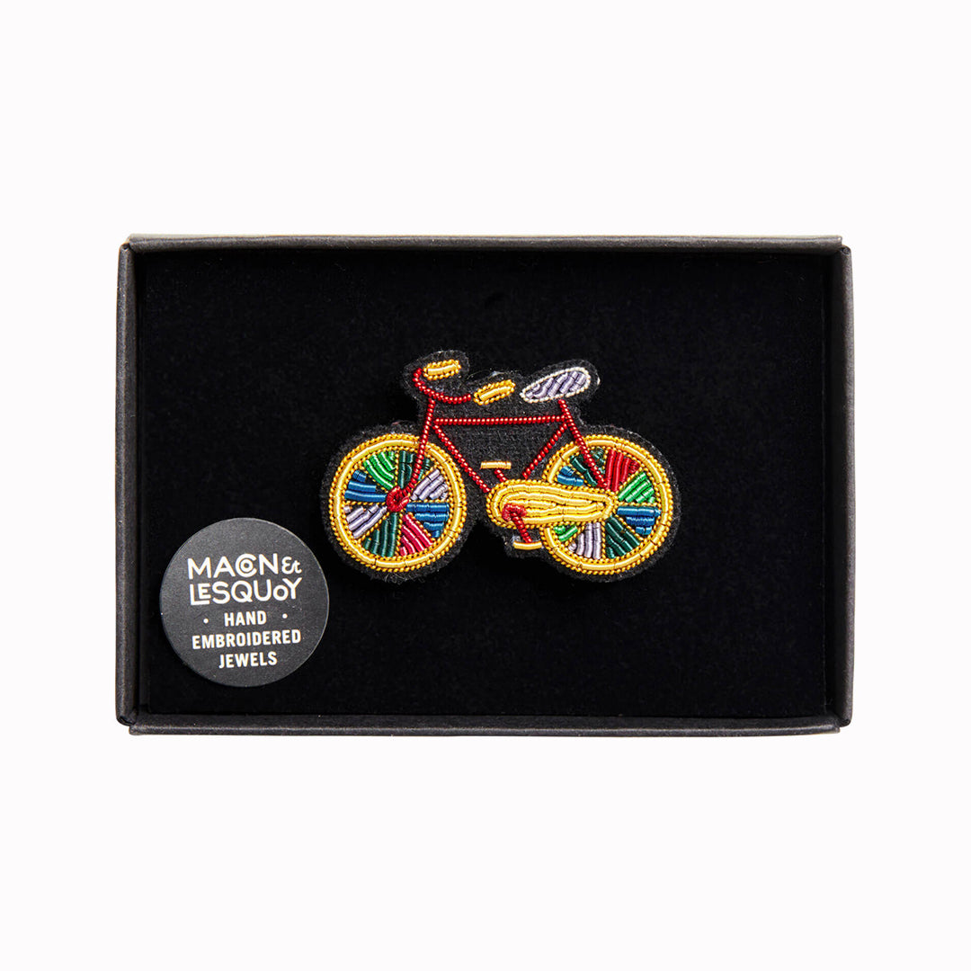 A beautiful hand-embroidered lapel pin for bike lovers everywhere in a presentation box From Macon & Lesquoy, French Hand Embroidered badges and patches using Cannetille thread.