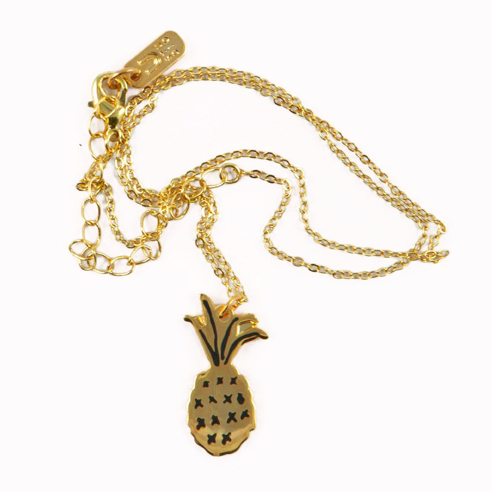 Gold plated Pineapple necklace by Katy Welsh for USTUDIO presented on a laser-etched birch ply board.