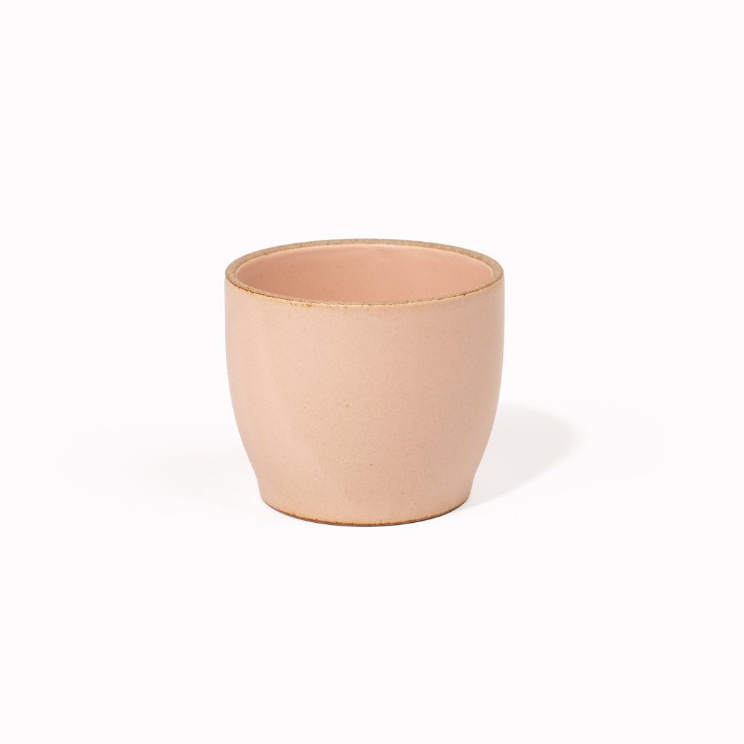 The 200ml Pink Nori Porcelain Tumbler is a Japanese manufactured small tea, coffee, or juice cup from Kinto. The porcelain has a tactile sloping side and smooth finish which feels pleasing in your hands. The glaze is a tasteful matt pink stone with raw porcelain edges in the Japanese style. 