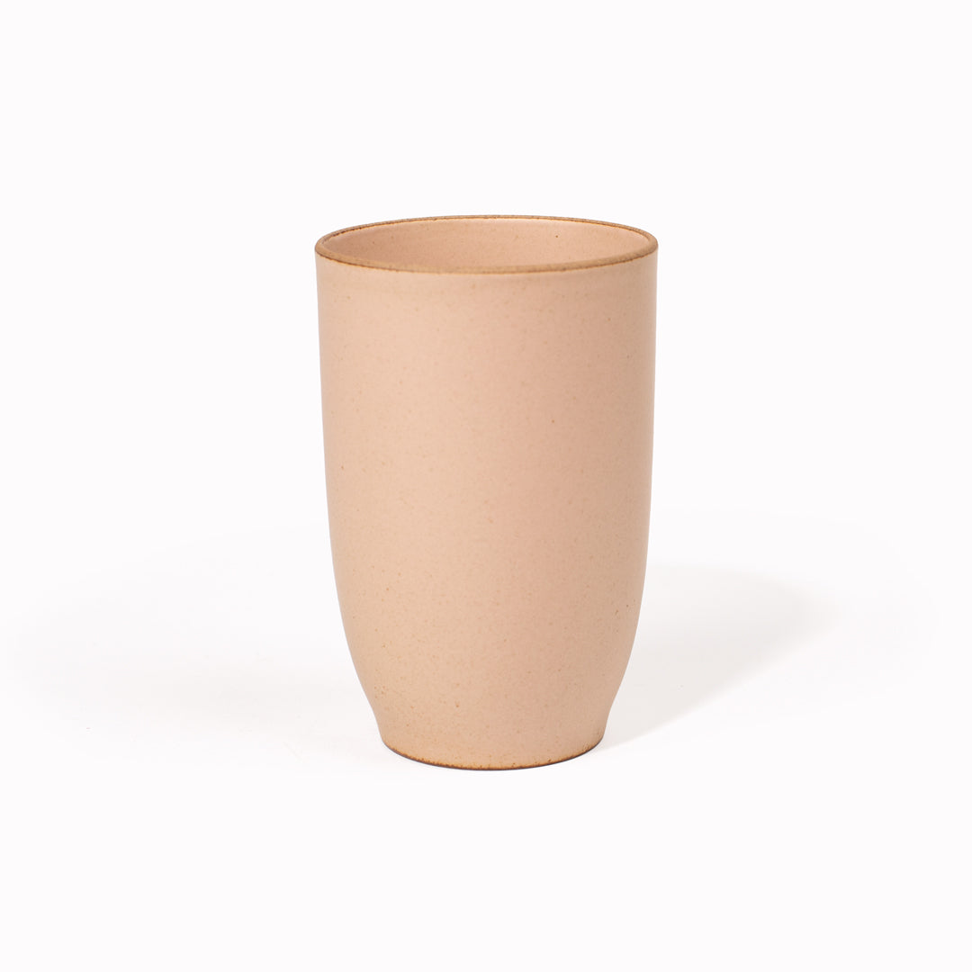The 350ml Pink Nori Porcelain Tumbler is a Japanese manufactured tall pink tea, coffee or juice cup from Kinto.  The porcelain has a tactile sloping side and smooth finish which feels pleasing in your hands. The glaze is a tasteful matt pink stone with raw porcelain edges in the Japanese style. 