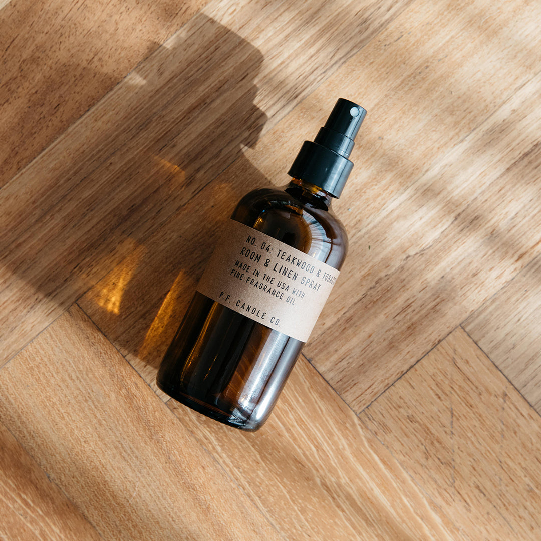 Room and Linen Spray with Teakwood and Tobacco Scent from PF Candle Co on a hardwood floor