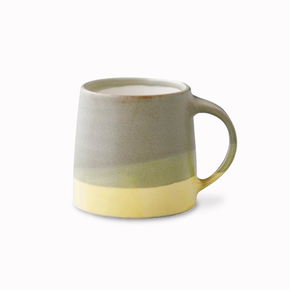The Slow Coffee Mug is a moss green and yellow chunky porcelain mug from Kinto, to be used as part of your slow coffee ritual. Enjoy a slow, relaxing passage of time and immerse in a deeper, richer, coffee time.