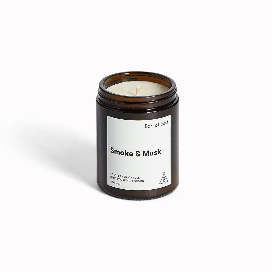 Smoke & Musk candle by Earl Of East, evoking the essence of the great outdoors. A comforting combination of of green balsam fir, wood smoke and patchouli.