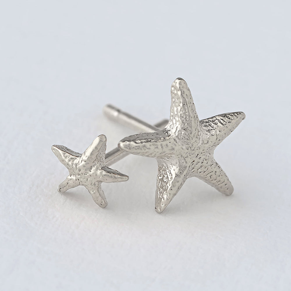 Silver Asymmetric Starfish stud earrings close up by Alex Monroe. Jewellery made in England.