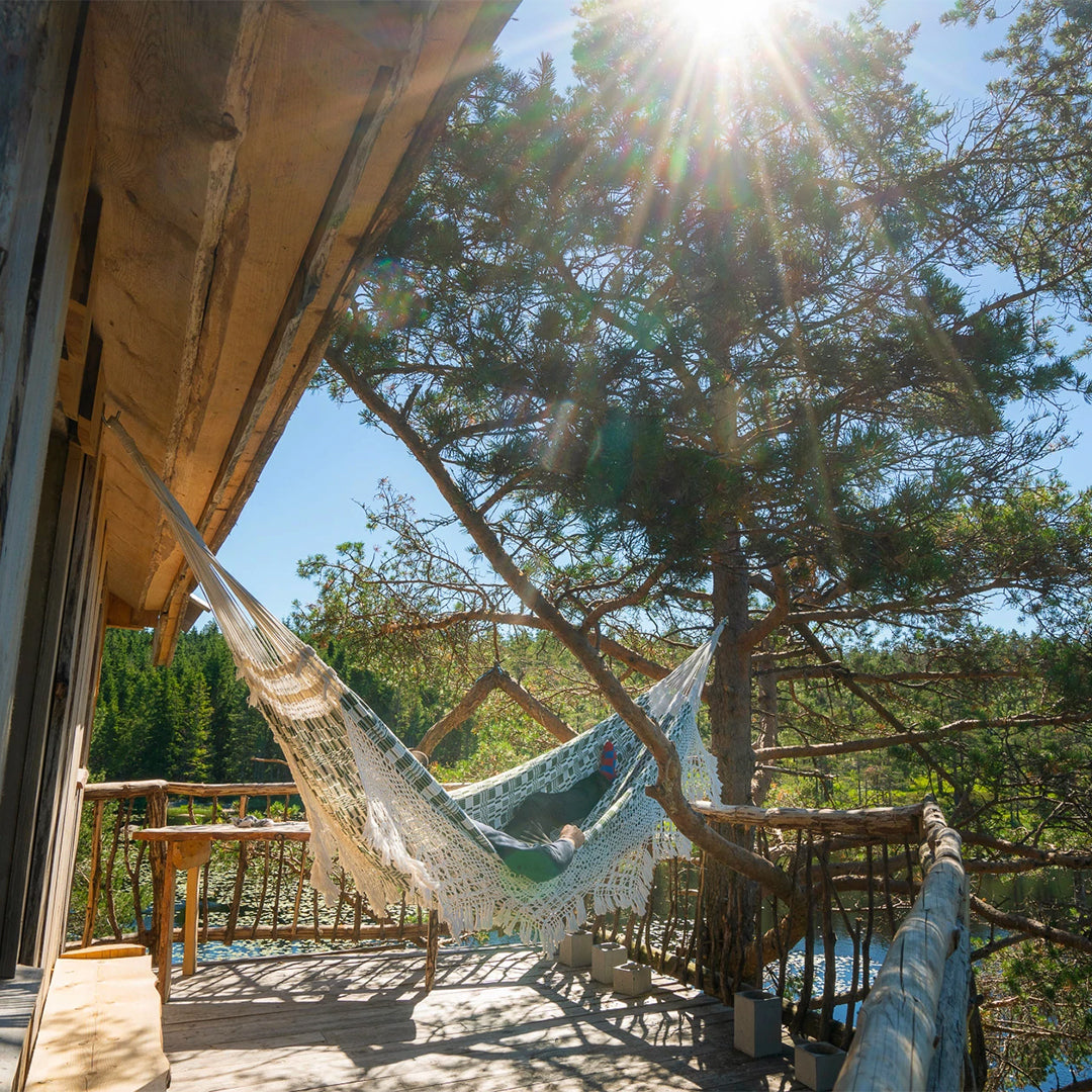Stay Wild Travel Book, Detail, Hammock on Deck. From towering treehouses, compact cabins, houseboats, yurts, and mobile homes that let you cook your meals al fresco whilst the campfire flickers, this book showcases alternative travel’s astounding diversity and enriching qualities.