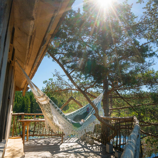 Stay Wild Travel Book, Detail, Hammock on Deck. From towering treehouses, compact cabins, houseboats, yurts, and mobile homes that let you cook your meals al fresco whilst the campfire flickers, this book showcases alternative travel’s astounding diversity and enriching qualities.
