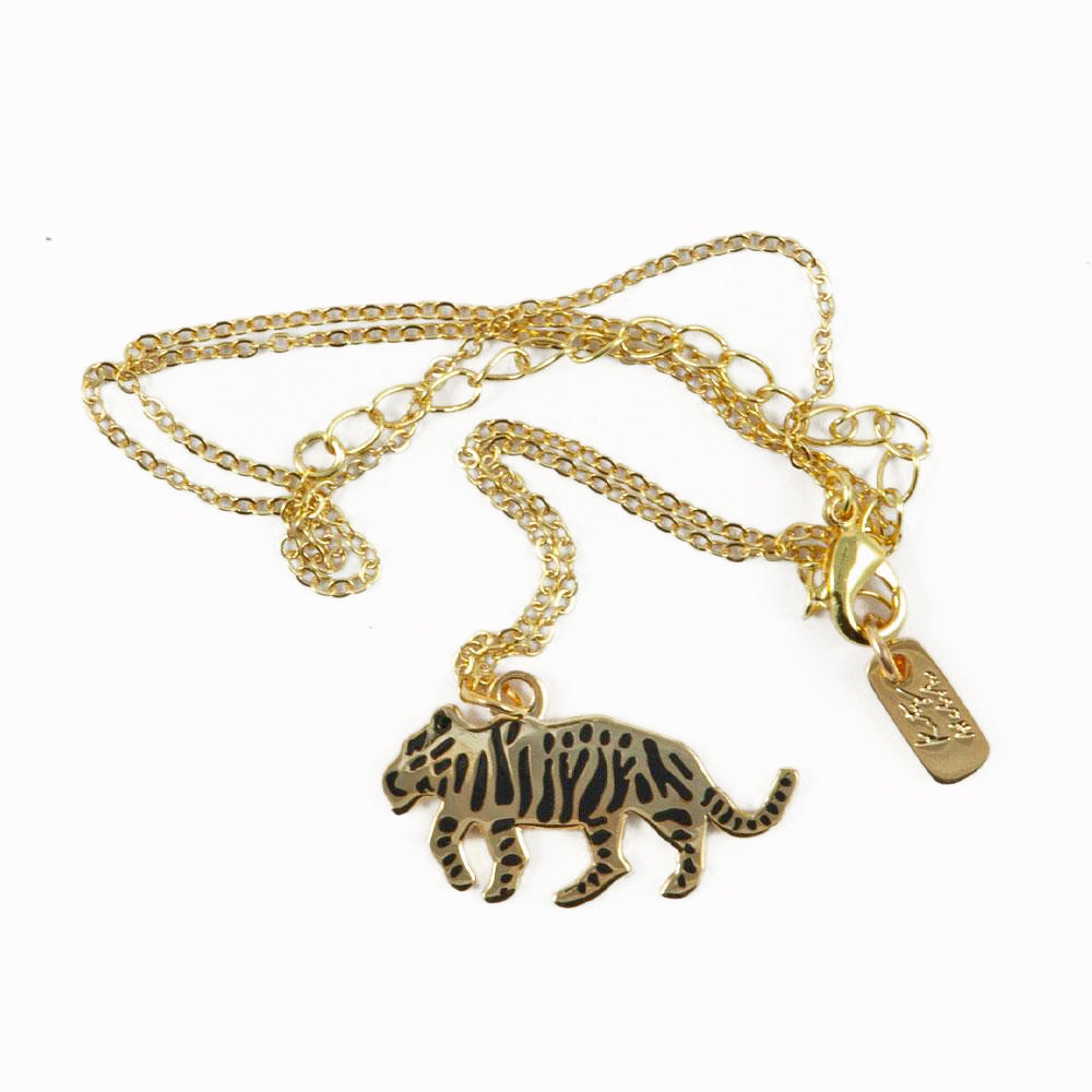 Gold plated Tiger necklace from Katy Welsh for USTUDIO presented on a laser-etched birch ply board.