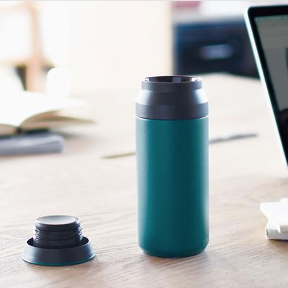 Stainless steel double walled vacuum tumbler from Kinto on table, will keep drinks either hot or cold for up to 6 hours.