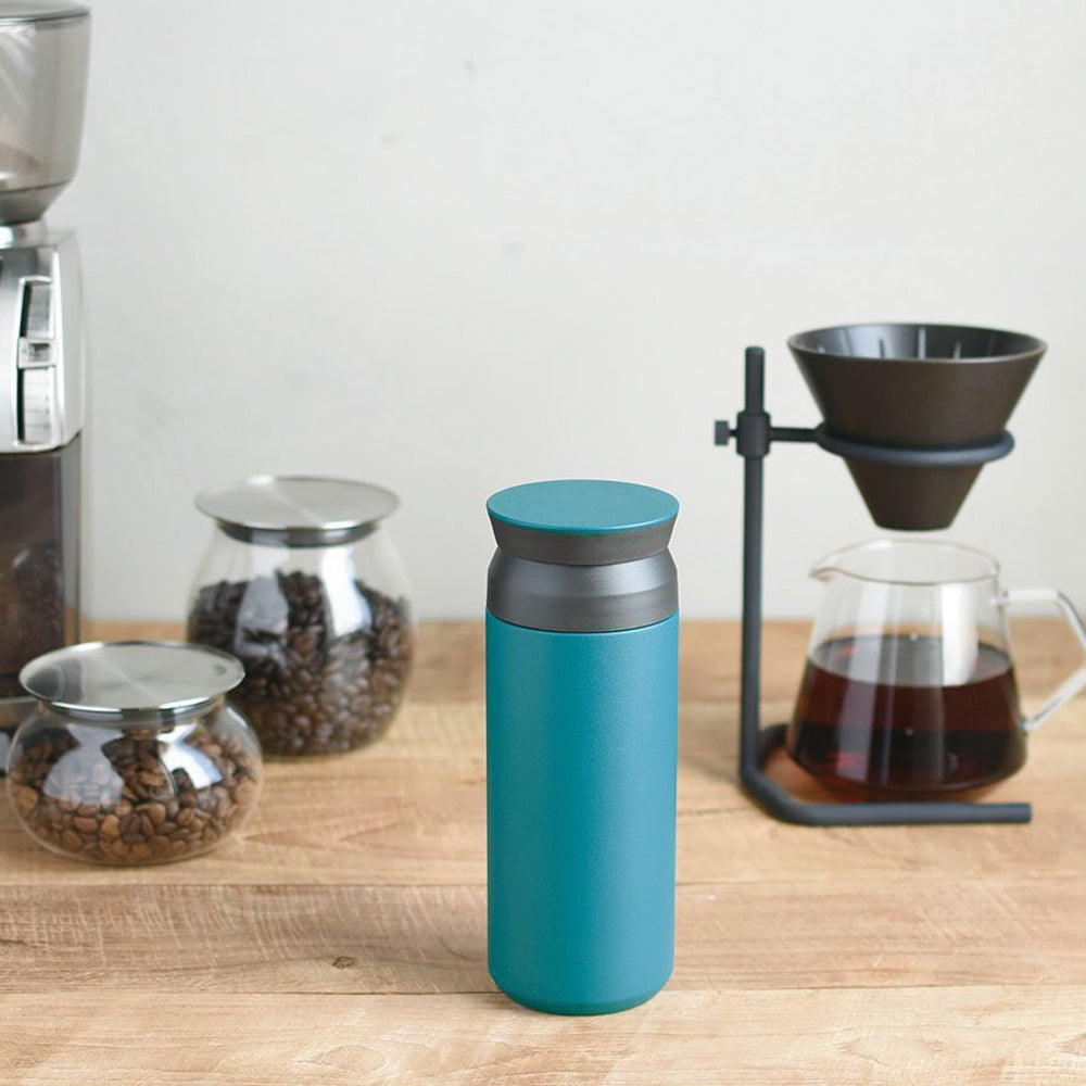Turquoise Stainless steel double walled vacuum tumbler in either 500 or 350ml from Kinto on table with slow coffee jug and brewer. The tumbler will keep drinks either hot or cold for up to 6 hours.