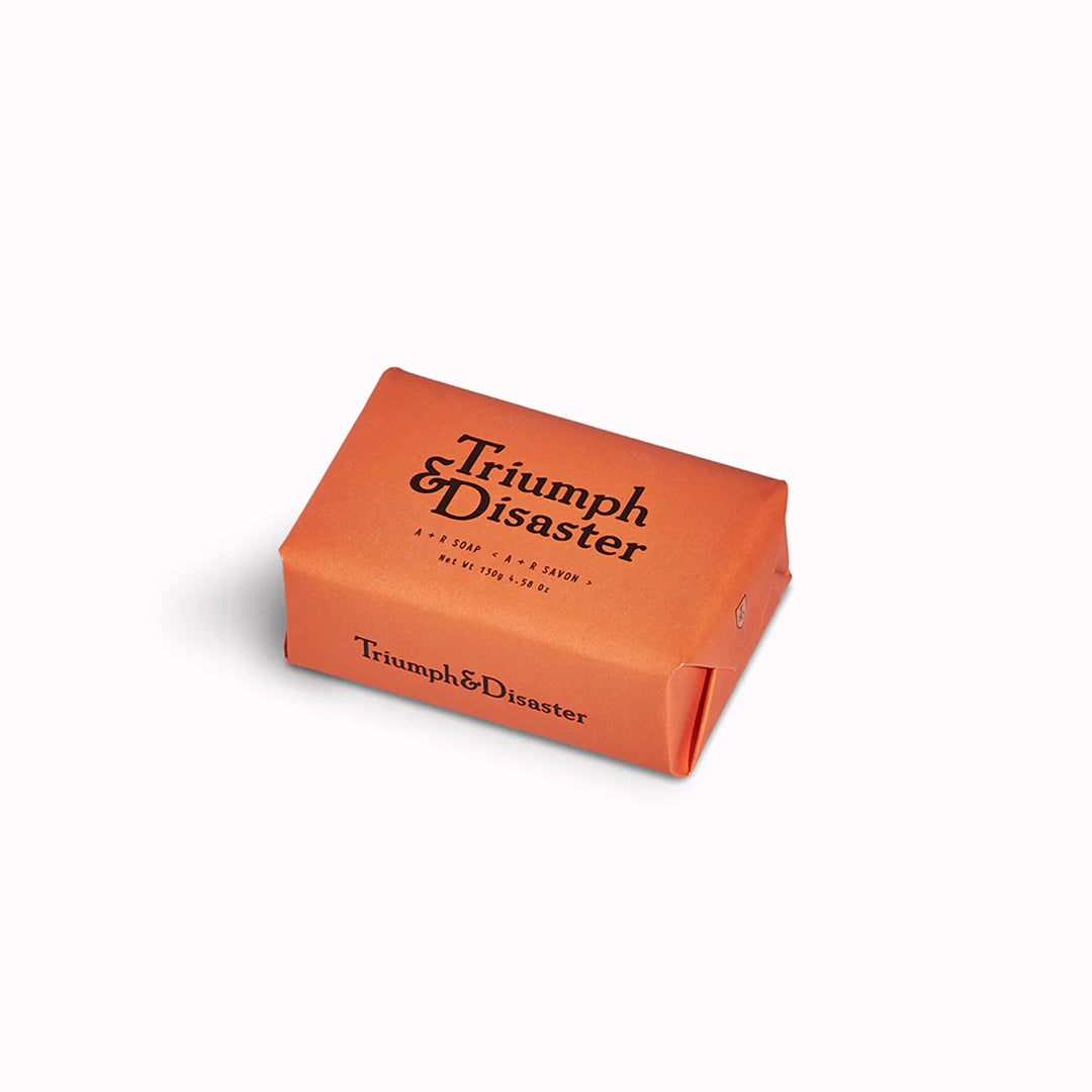Infused with an exotic blend of Cedar, Juniper, Cypress and Bergamot, A+R soap from Triumph and Disaster Soap is a gentle, soft soap with high glycerin content meaning it will not dry out your skin like most soaps do. - viewed on table