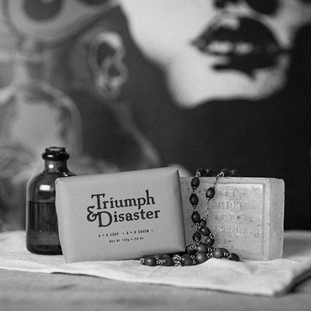 Infused with an exotic blend of Cedar, Juniper, Cypress and Bergamot, A+R soap from Triumph and Disaster Soap is a gentle, soft soap with high glycerin content meaning it will not dry out your skin like most soaps do. lifestyle image with necklace on towel