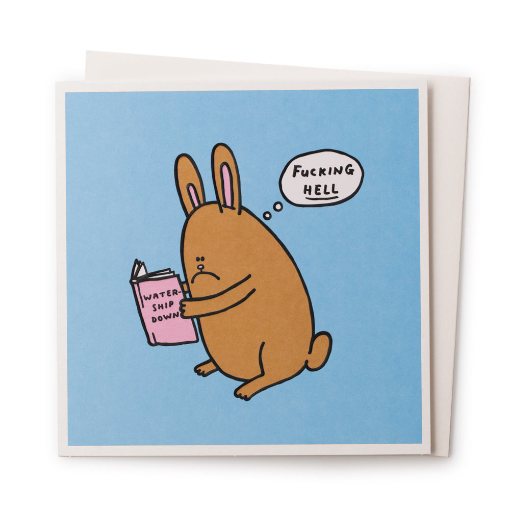 'Watership Downer' is a funny illustrative greeting card by Al Murphy for USTUDIO featuring a sad faced bunny rabbit thinking an expletive, whilst reading a copy of the classic animal themed novel 'Watership Down' by Richard Adams.