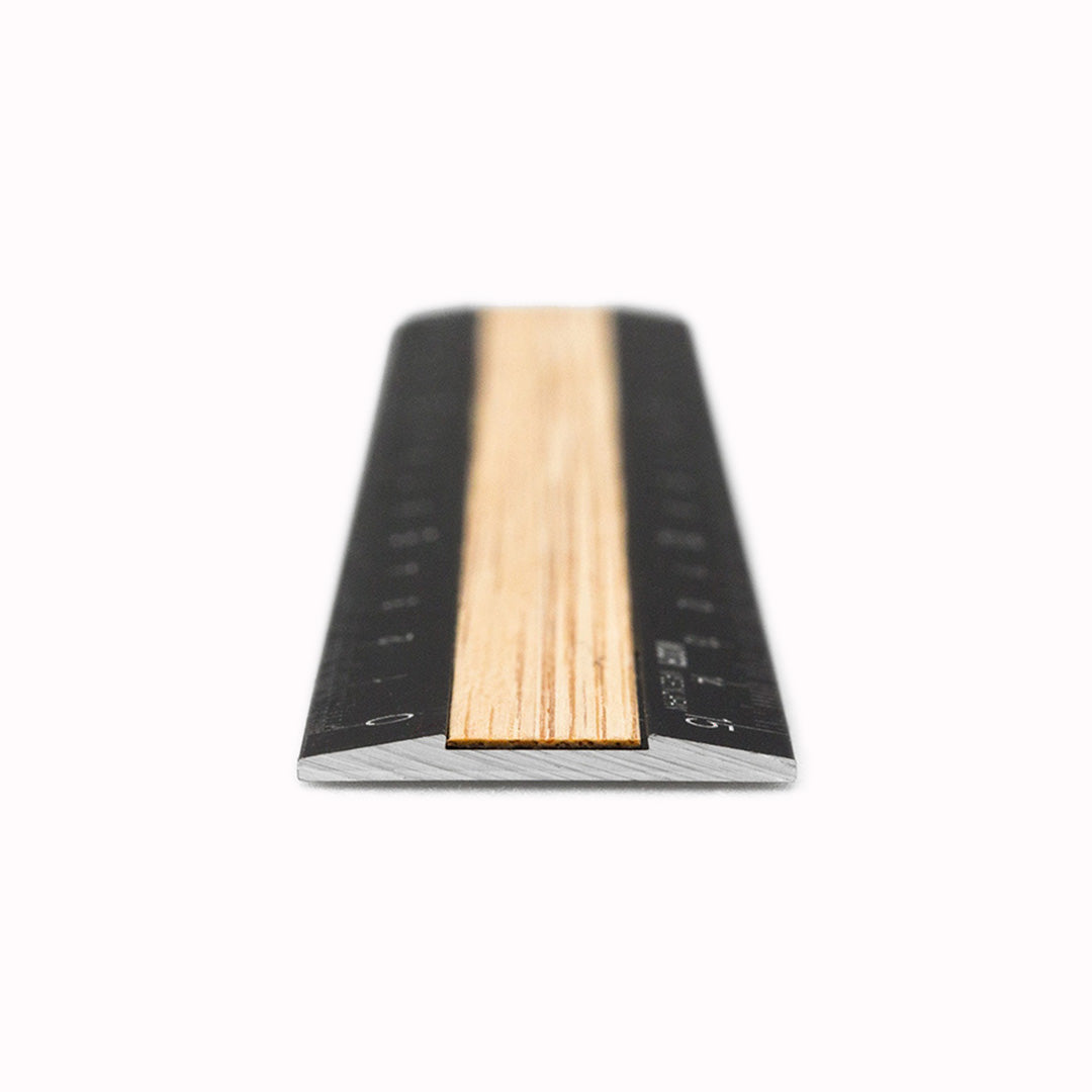 End on detail of a  stylish ruler with a bamboo texture and a black aluminum body. A 15cm ruler from Japanese Stationery manufacturer Midori