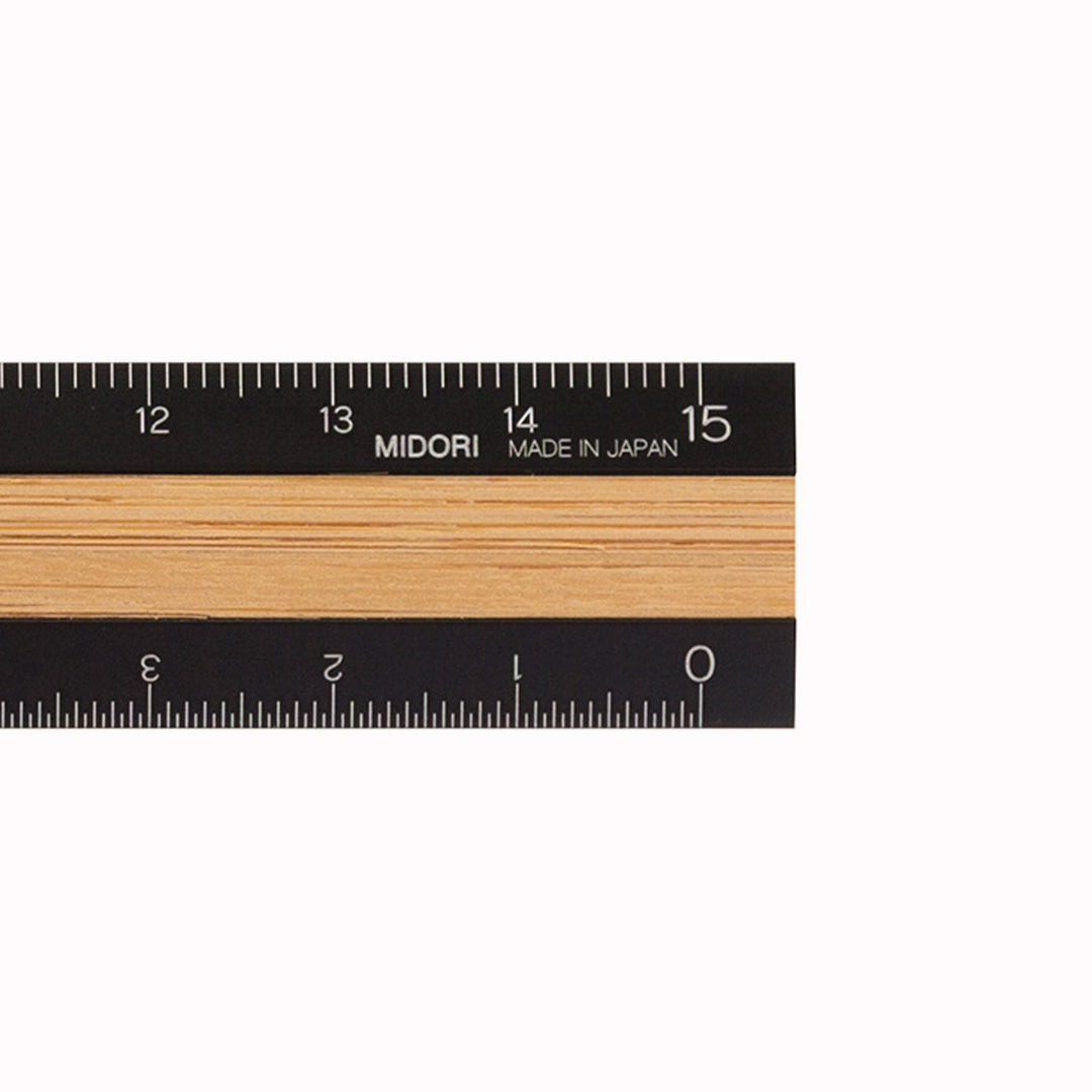 Above Detail of a stylish ruler with a bamboo texture and a black aluminum body. A 15cm ruler from Japanese Stationery manufacturer Midori