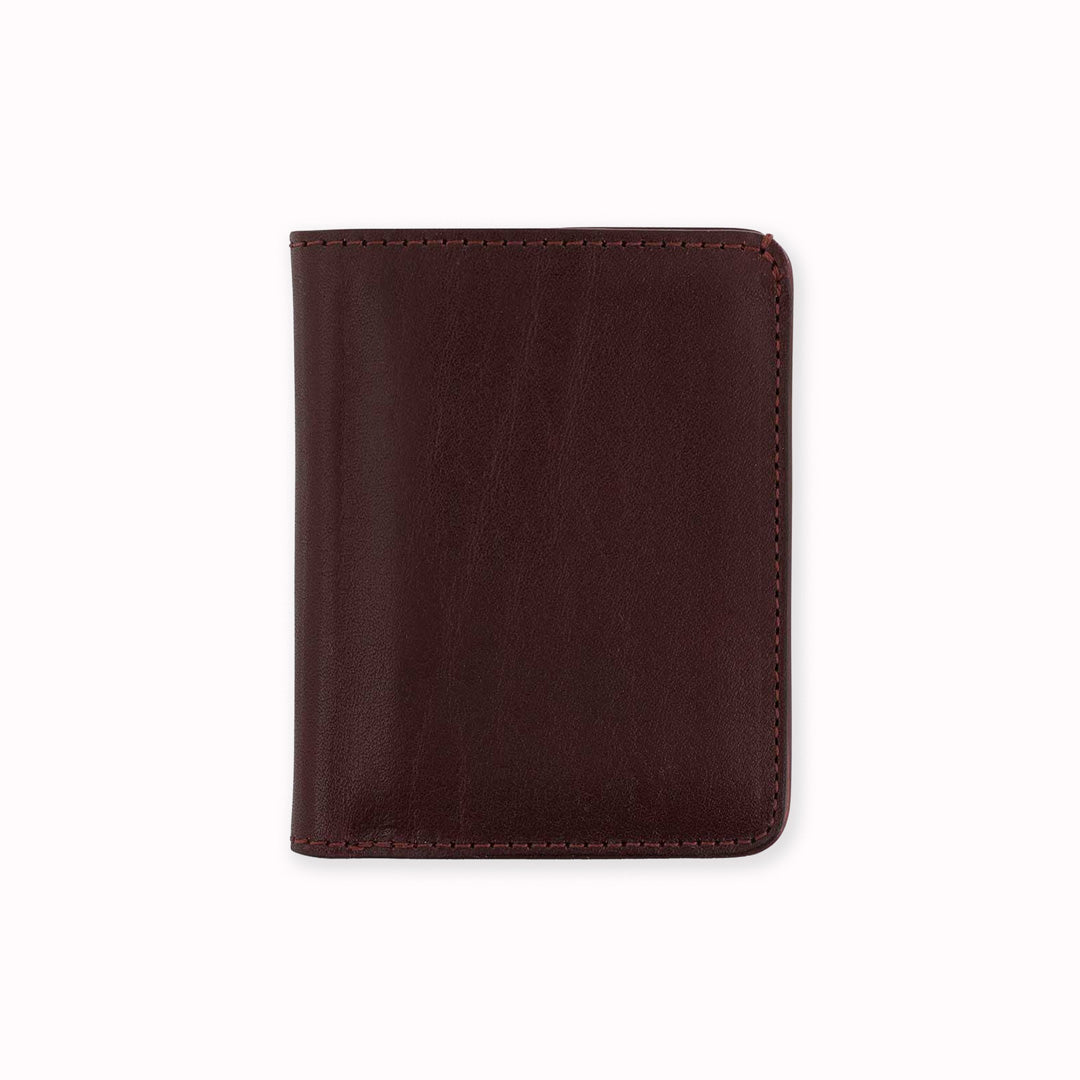 Slim Italian leather wallet from Escuyer, featuring two complementary red vegetable dyed colour tones for a subtle and stylish appearance - rich burgundy on the outside, bright red card slot feature on the inside. Handmade by Portuguese artisans using leather from a tannery in Tuscany