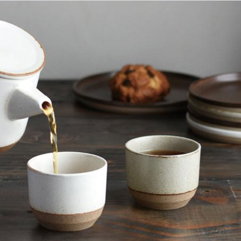 Ceramic Lab Tumblers on a table Collection from Kinto. This porcelain mug uses sandstone unique to the Hasami region in Japan. It gives the product a beautiful rough quality whilst also being delicate and a pleasure to use.