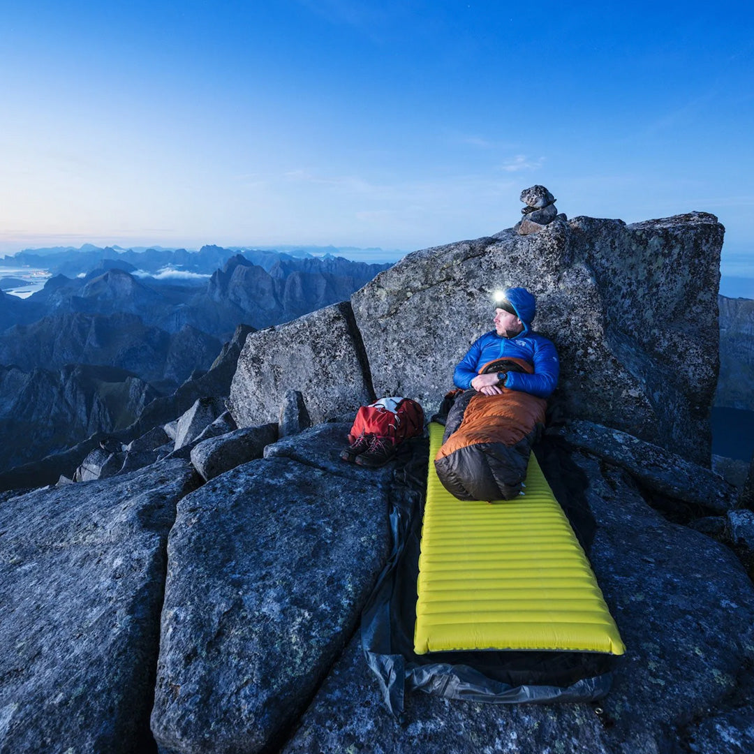 Man camping on a mountain top, Example Image from The Hidden Tracks by Gestalten. Embark on a thrilling exploration of the world’s most exciting, magnificent, and diverse walking trails and hiking destinations. Besides the better-known paths, The Hidden Tracks will also highlight some of the more out-of-the-way gems