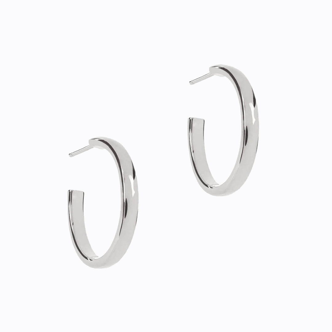 Weighty solid sterling silver Machinist hoop earrings by Matthew Calvin, which feel luxurious but are still comfortable for everyday wear. A classic design with a simple bold curve, fastened with a butterfly clasp.