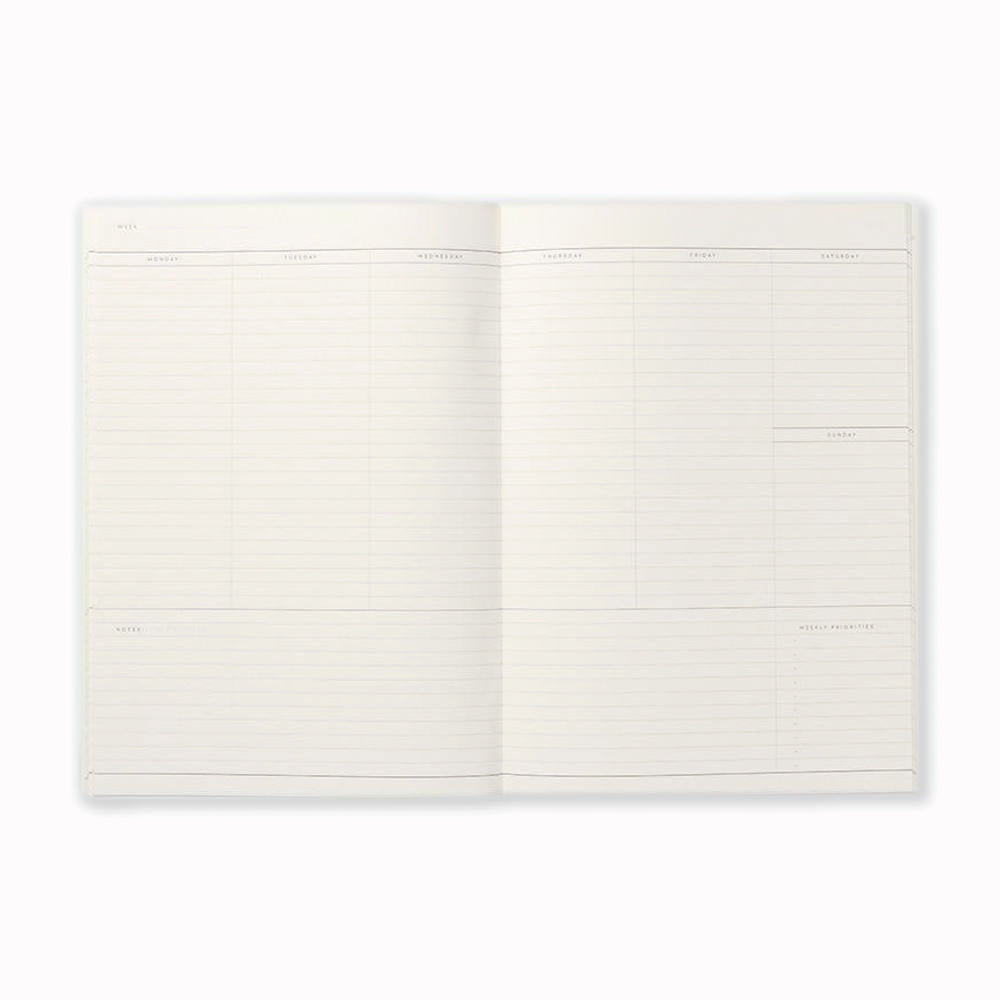 Inside spread of lined pages of NOTEM Milo weekly planner. The planner contains 23 undated weekly spreads and has a horizontal layout with space for notes and must-do's of the week. It is made of high-quality uncoated paper and has a soft cover in light grey or dark green.